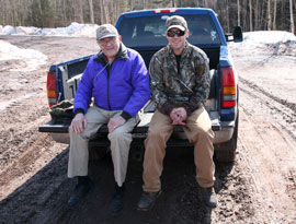 Earl and Colin on the tailgate of Colin's Truck